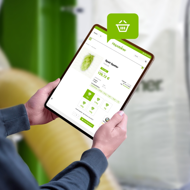 A person looks at a product detail page in the Hopsteiner Shop on a tablet.